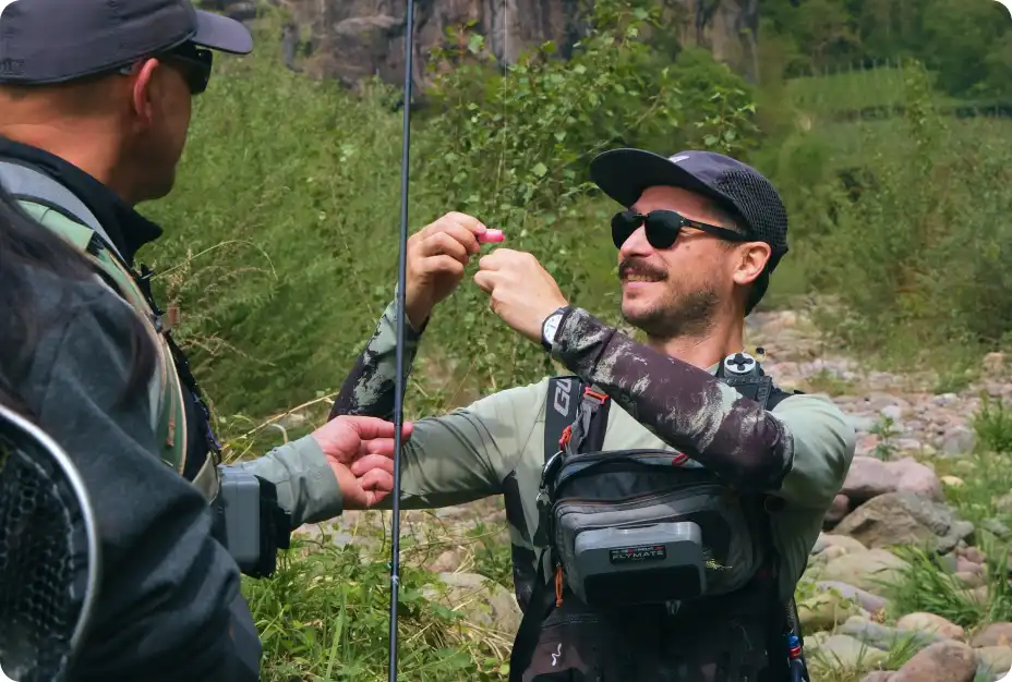 Guide helping an experienced angler tie on a nymph rig during an advanced euronymphing course